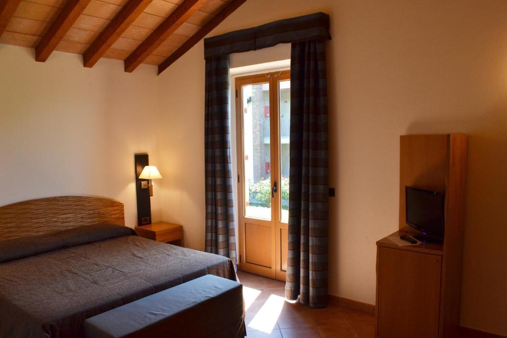Postel nebo postele na pokoji v ubytování Ariotto Village