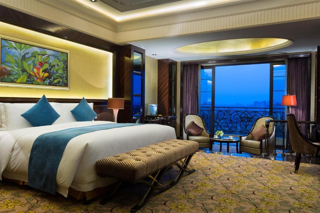 a bedroom with a large bed and a balcony at Howard Johnson Agile Plaza Chengdu in Chengdu