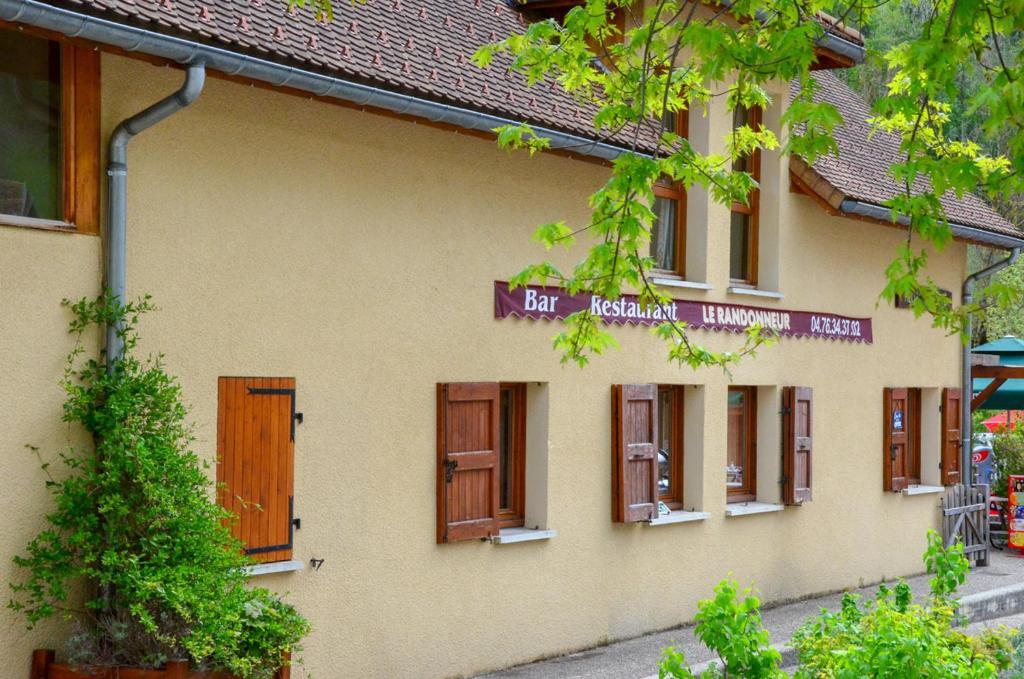 a building with windows and a sign on it at GITE DU MONT AIGUILLE in Chichilianne