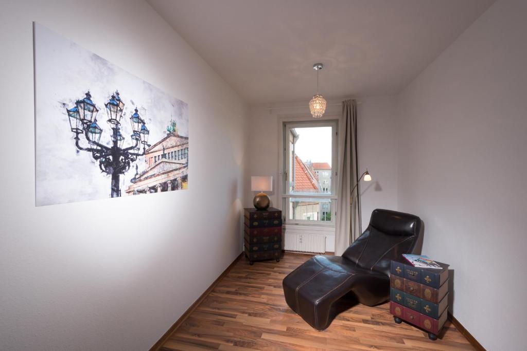 a room with a couch, chair and a wall at Apartments am Brandenburger Tor in Berlin