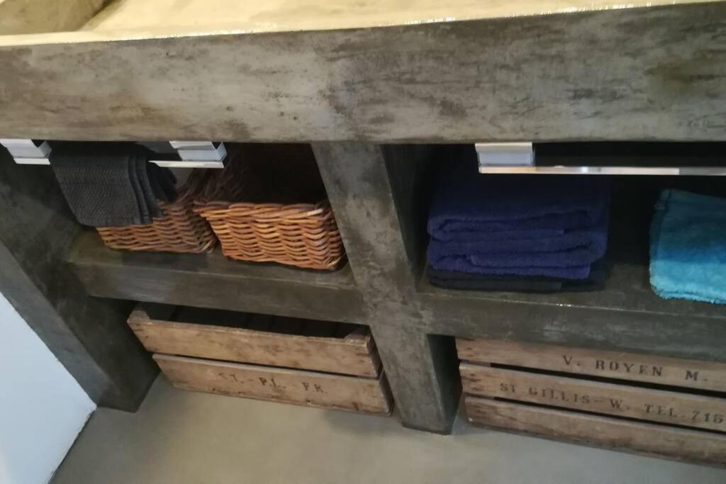 a table with towels and baskets under it at Suite Louise-Stephanie Brussels in Brussels