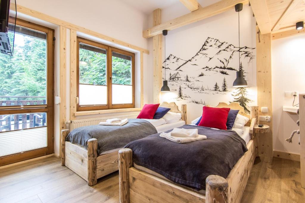 Posteľ alebo postele v izbe v ubytovaní Apartamenty Orkana Centrum Zakopane