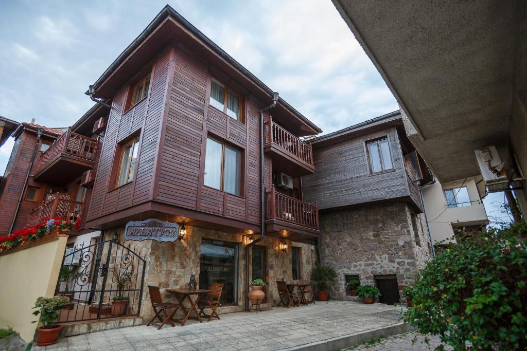 a large building with tables and chairs in front of it at Hotel Albatros Old Town in Sozopol