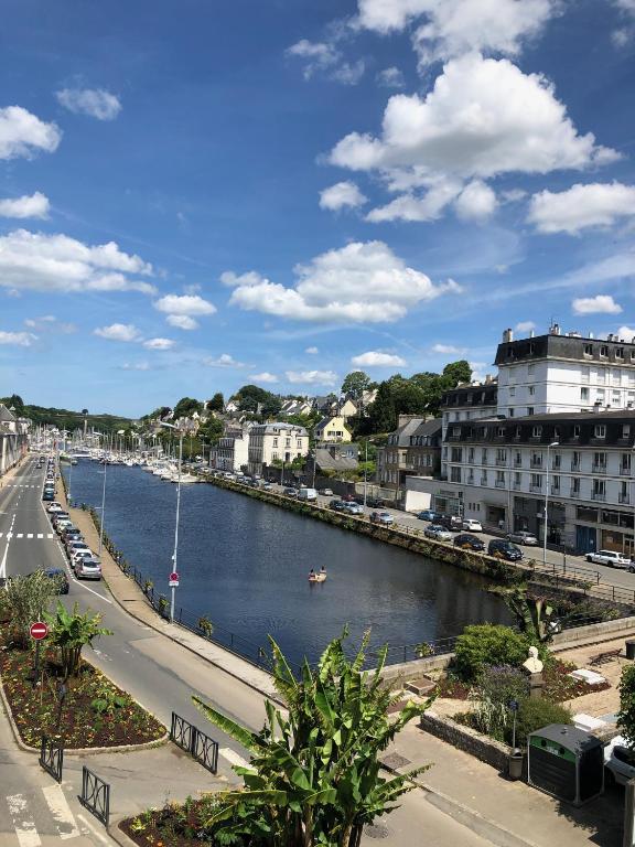 a view of a river with a boat in it at hotel de Croix in Morlaix