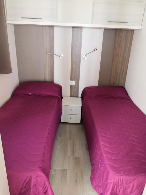 Postel nebo postele na pokoji v ubytování CAMPING TRE ARCHI
