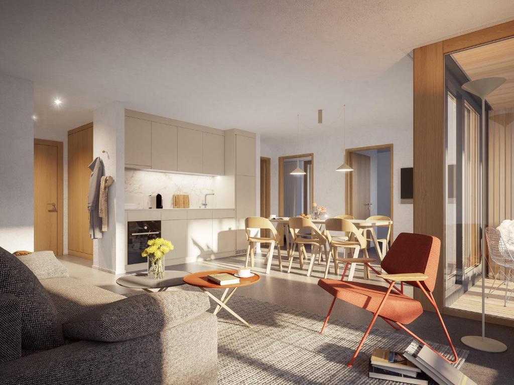 a living room and dining room with a couch and chairs at The Hide Apartments in Flims