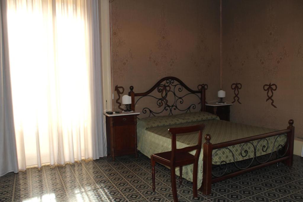 Postel nebo postele na pokoji v ubytování B&B Conte Ruggero