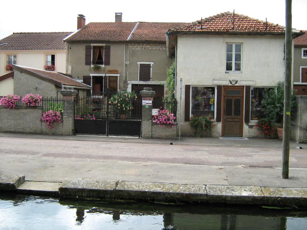 a house next to a body of water at Chez Monique in Doulaincourt