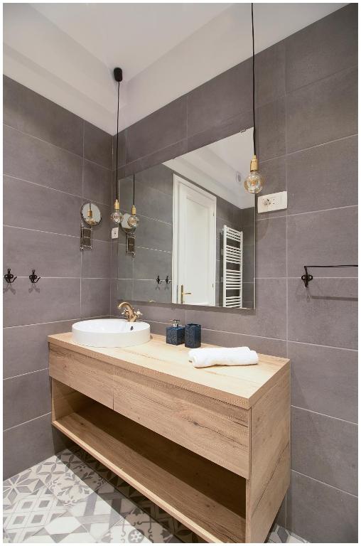 a bathroom with a sink and a mirror at Stylish - Centre Apartment Theatre View in Rijeka