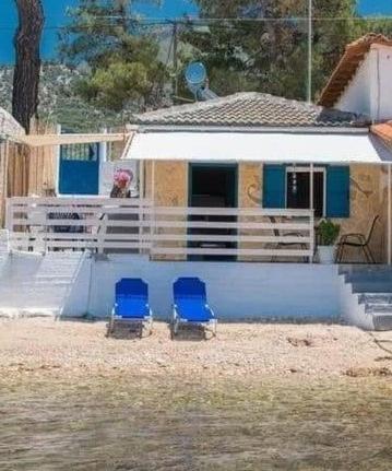 two blue chairs sitting in front of a house at Julie's Hermes house in Skala Kallirachis