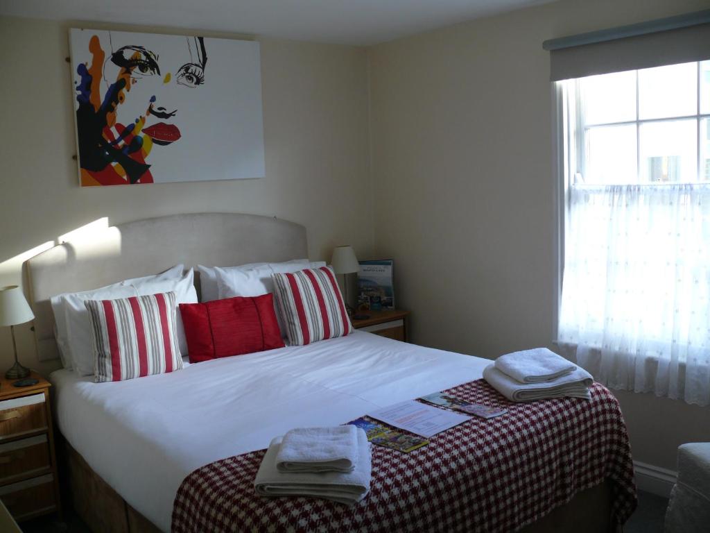 a bedroom with a bed with two towels on it at Bow Street Runner in Brighton & Hove