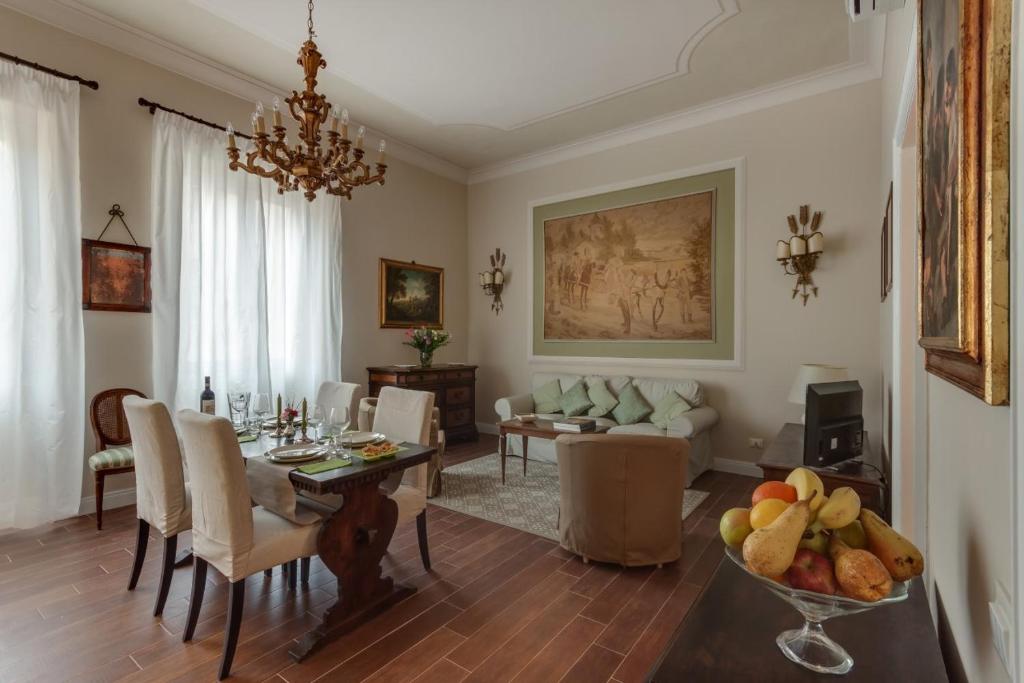 a living room with a table and a dining room at Ricasoli Charme in Florence