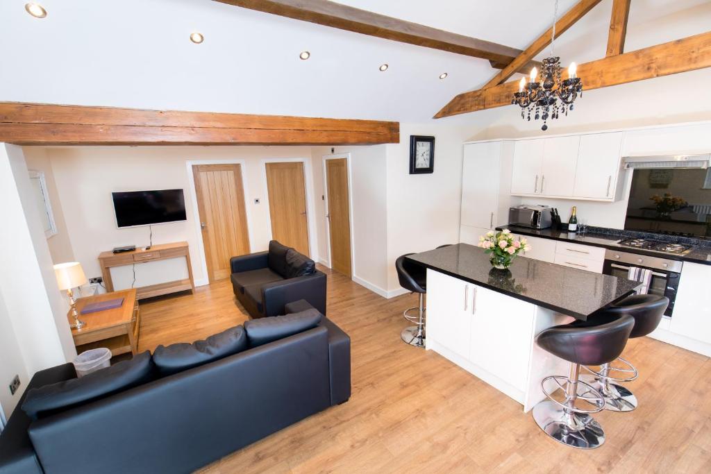 a kitchen and living room with a couch and a table at Villa Farm York in York