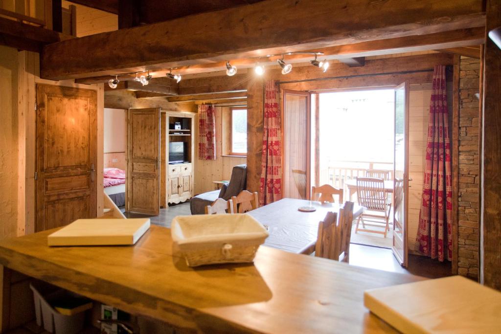 ein Esszimmer und ein Wohnzimmer mit einem Tisch und Stühlen in der Unterkunft Chalet l'aubépine résidence B&B in Bessans