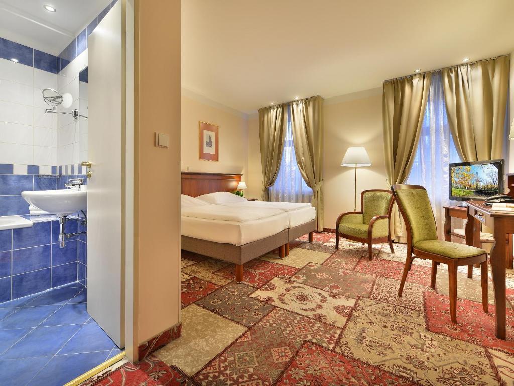 Postel nebo postele na pokoji v ubytování EA Hotel Jeleni Dvur Prague Castle