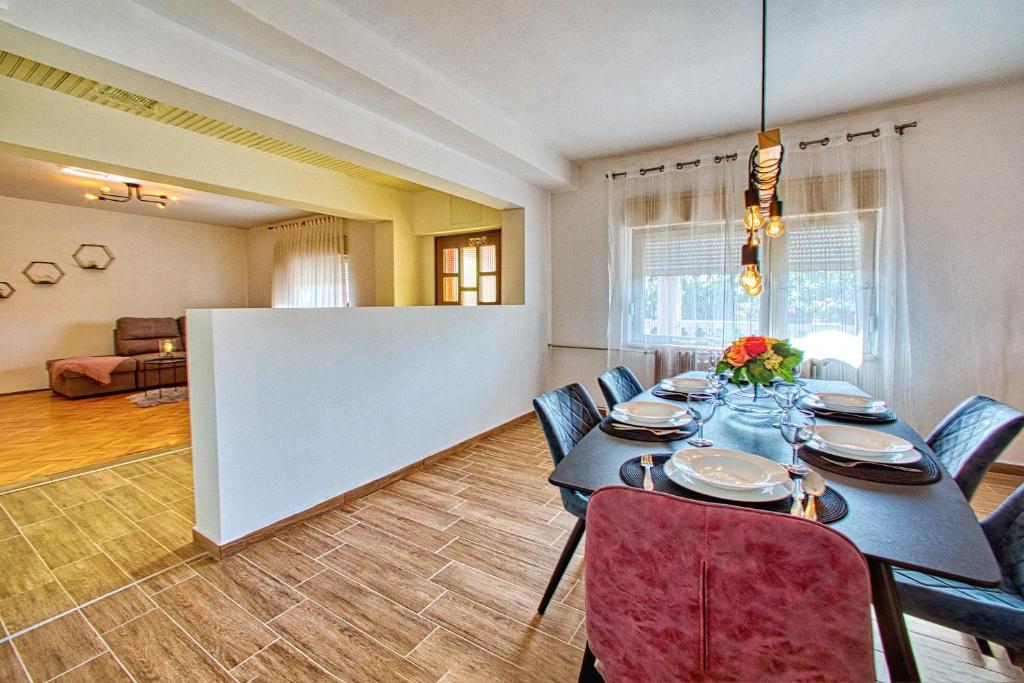 a dining room with a long table and chairs at Sara in Bibinje