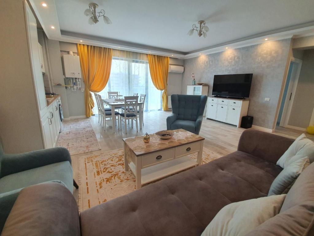 a living room with a couch and a table at Evys Apartment in Mamaia Sat/Năvodari