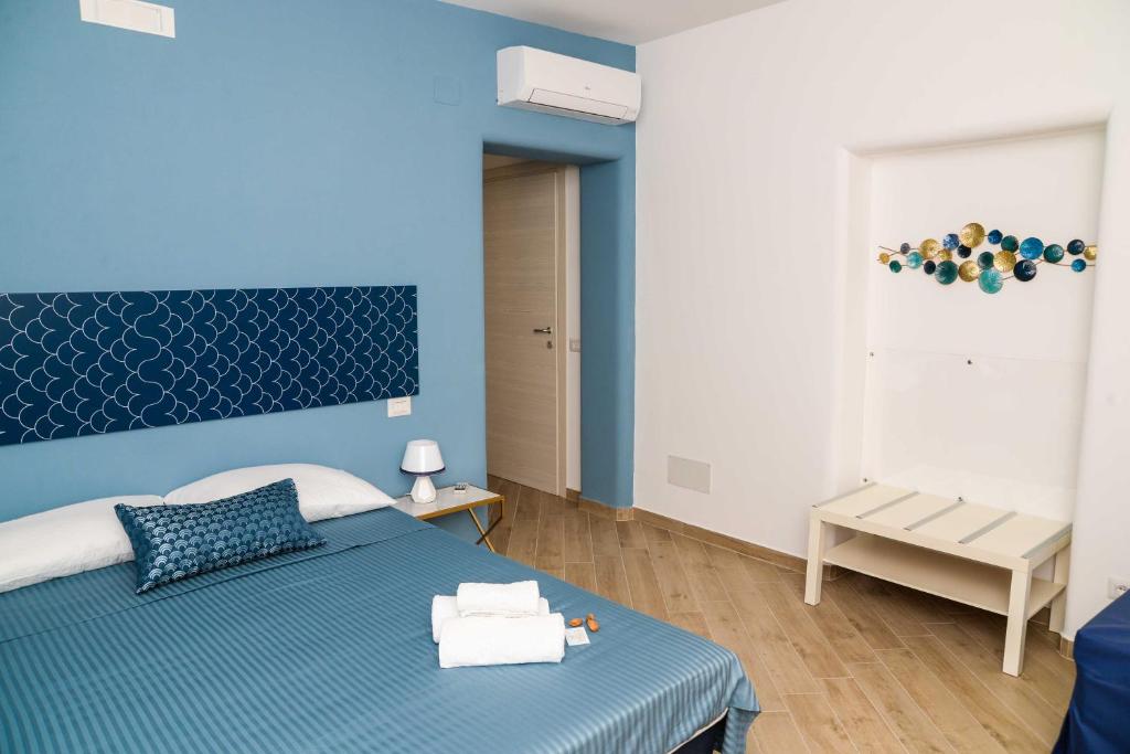 a blue bedroom with a bed and a blue wall at ‘A Minnula in San Cataldo