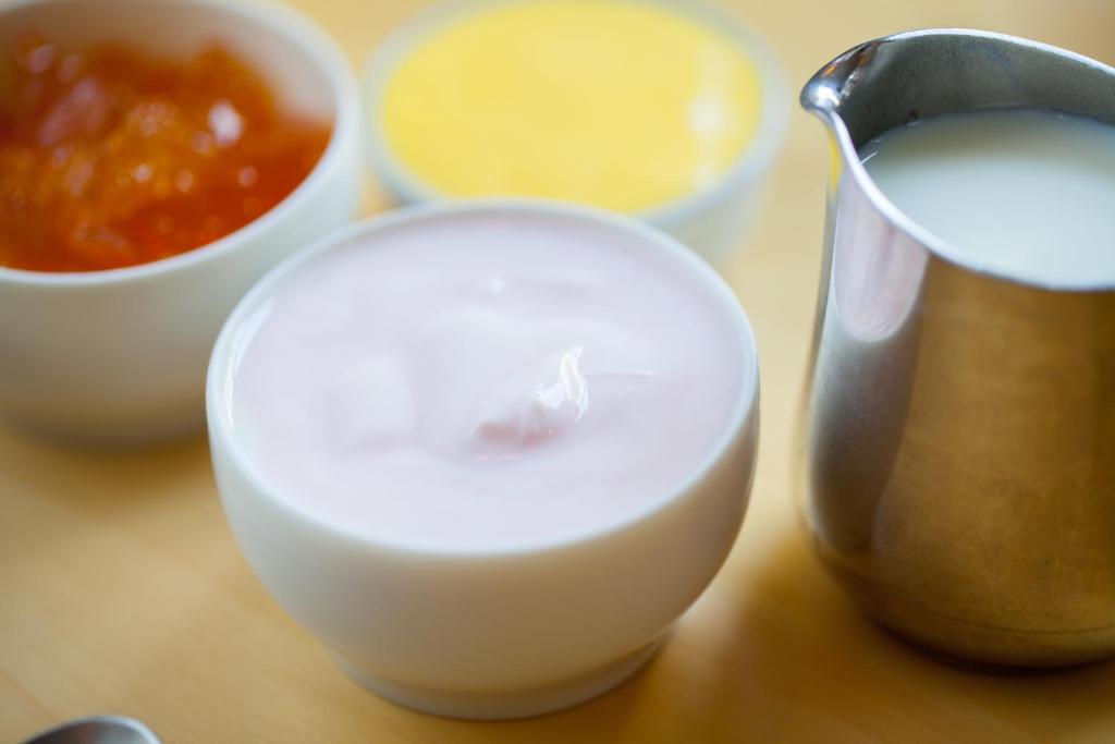 a close up of a bowl of liquid next to a spoon at Hill View House in Dartmouth