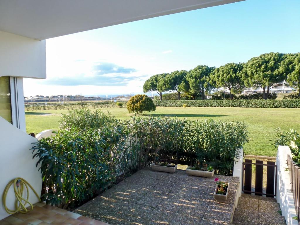 a garden with a view of a field at Studio La Lagune by Interhome in Le Grau-du-Roi