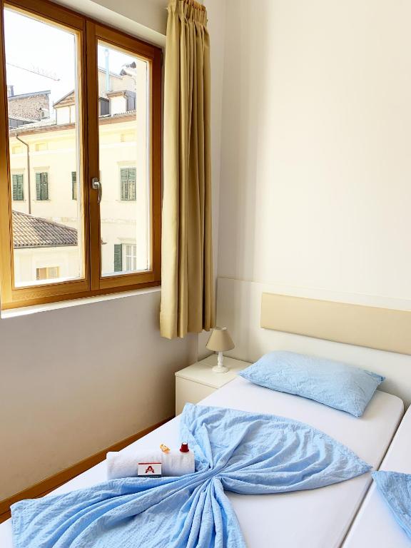 Łóżko lub łóżka w pokoju w obiekcie Argentieri Guesthouse