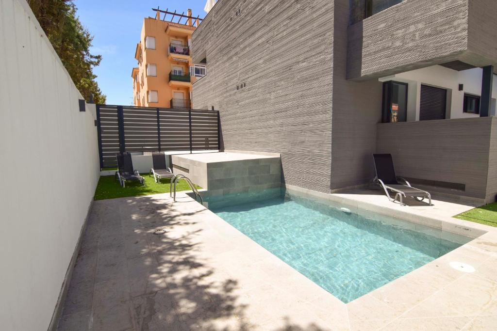 a swimming pool in the backyard of a house at Letmalaga Carlos Haya in Málaga
