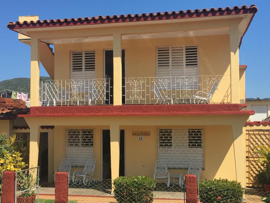 a house with a balcony with chairs on it at Casa Carlos Valido in Viñales