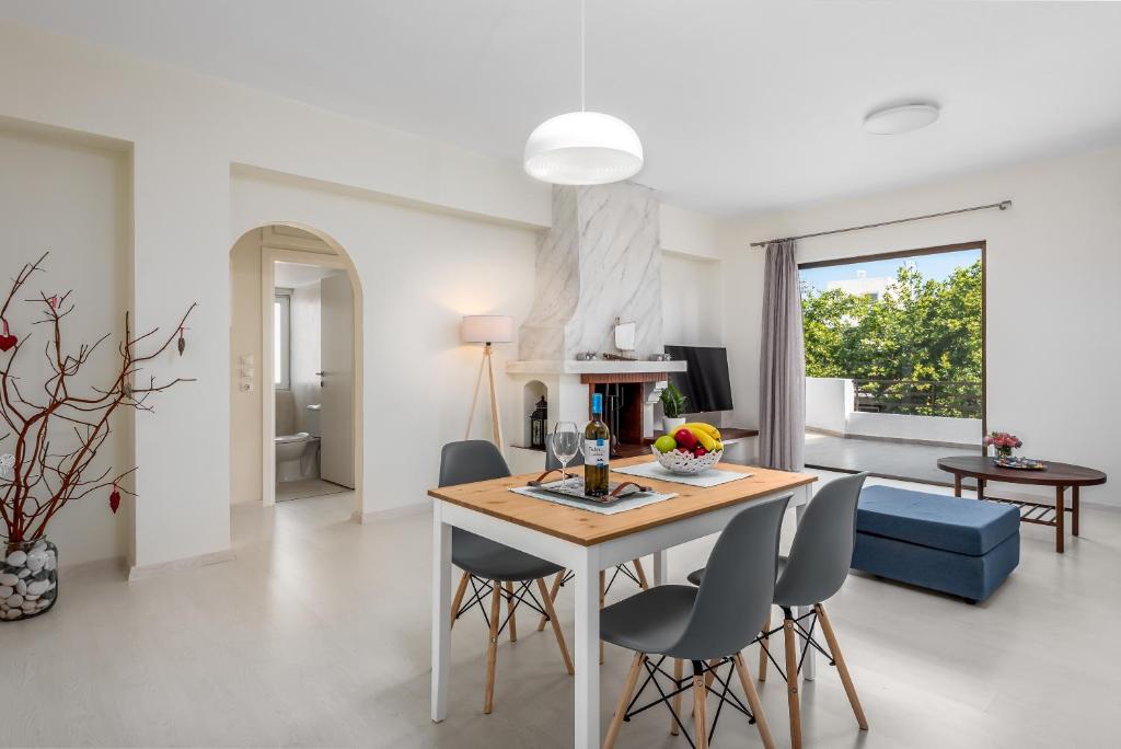 a kitchen and living room with a table and chairs at City apartment in Rhodes Town