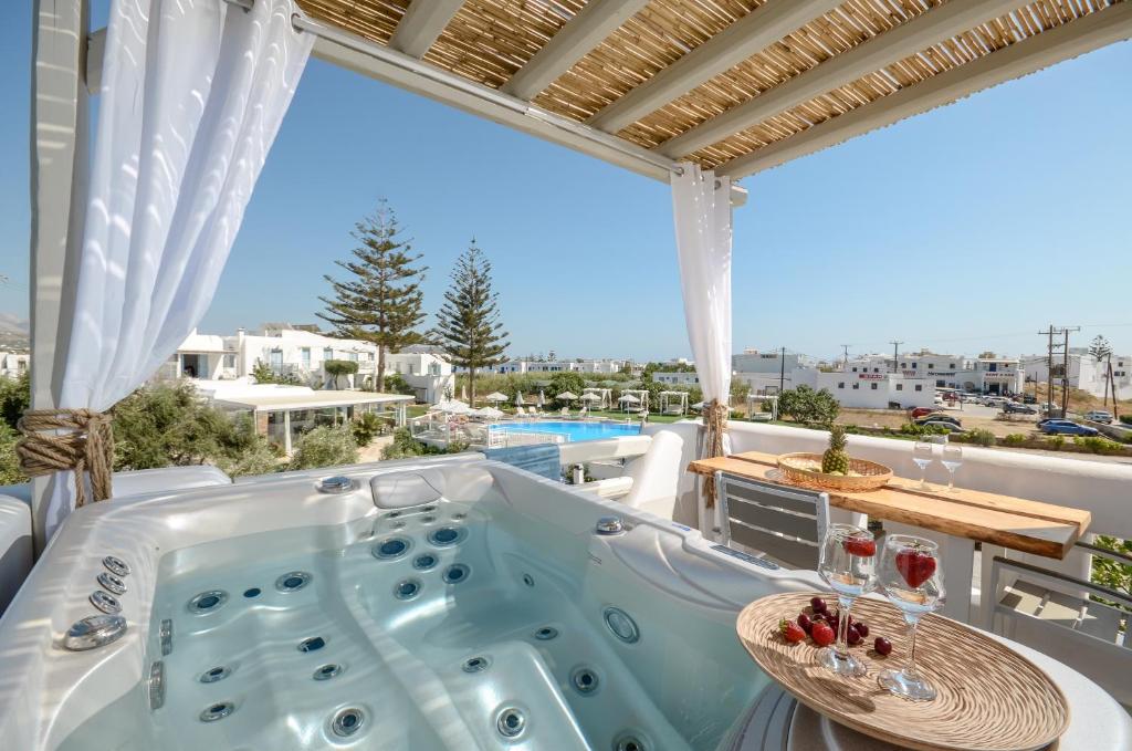 a hot tub on the balcony of a house at Naxos Nature Suites in Agios Prokopios