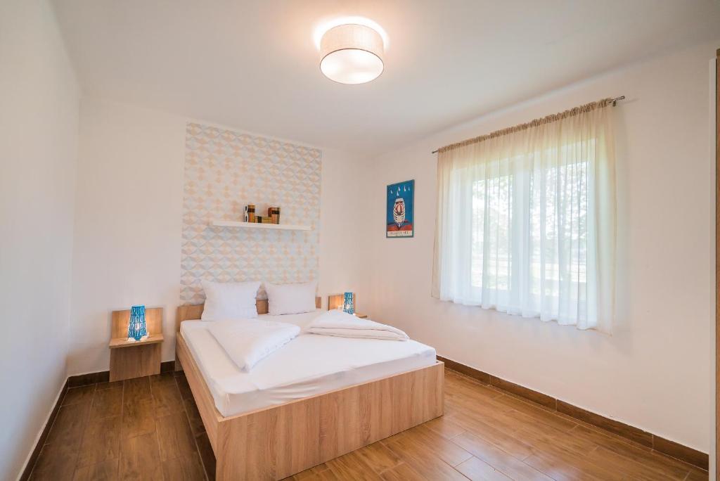 Posteľ alebo postele v izbe v ubytovaní Villa Magdolna