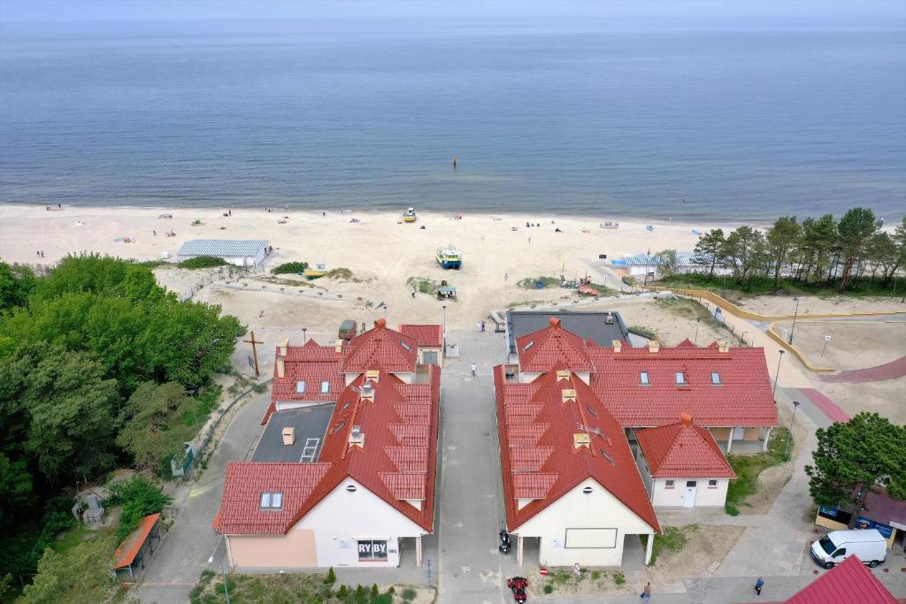 an aerial view of a beach with red roofs at DALBA pokoje przy samej plaży in Krynica Morska