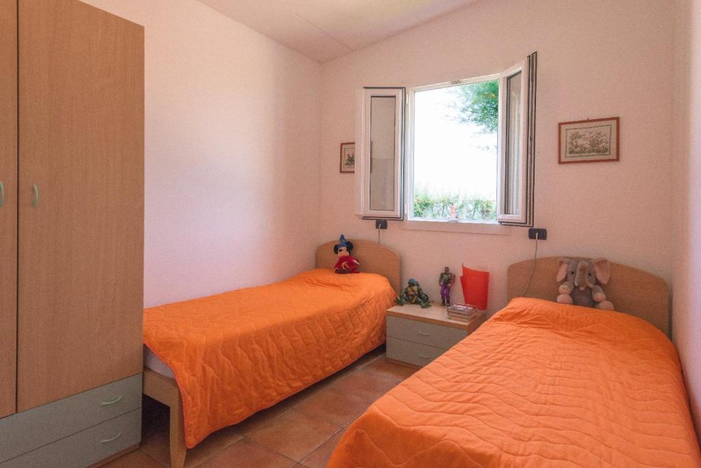 Postel nebo postele na pokoji v ubytování CAMPING TRE ARCHI