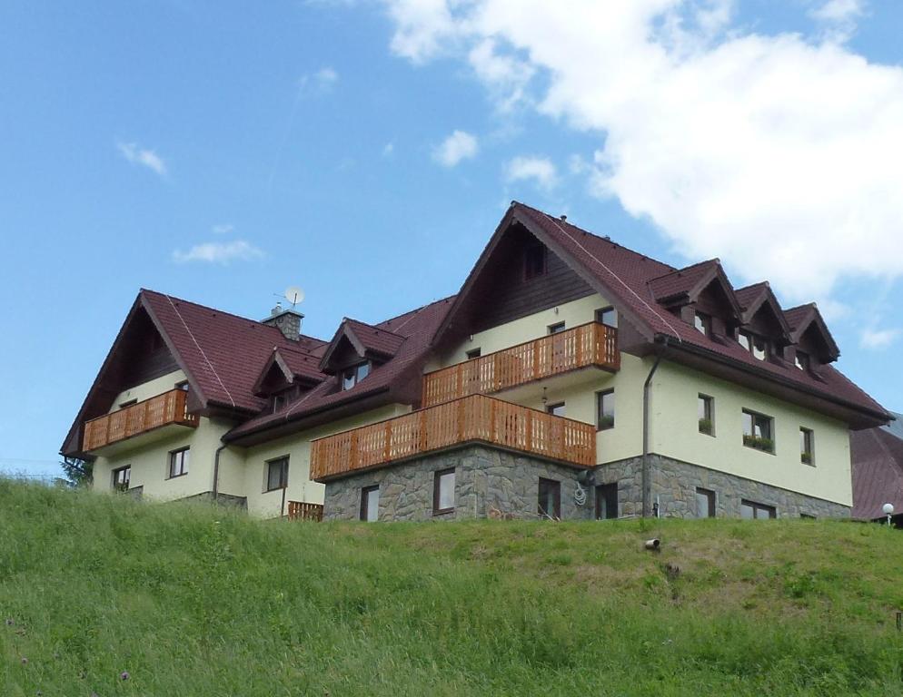 a large house on top of a hill at Penzión Bachleda in Ždiar
