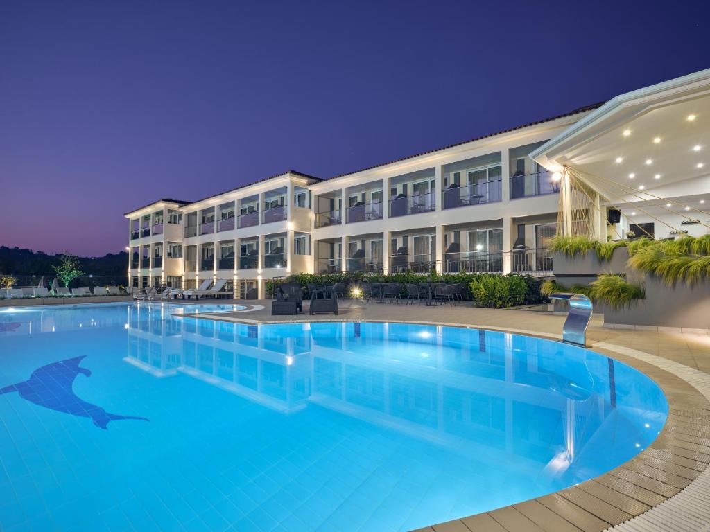 a swimming pool in front of a hotel at night at Park Hotel & Spa-Adults Only in Tsilivi