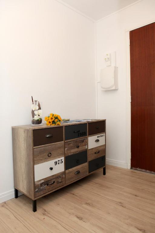 a wooden dresser in a room with a white wall at Résidence La Corvette in Toulon
