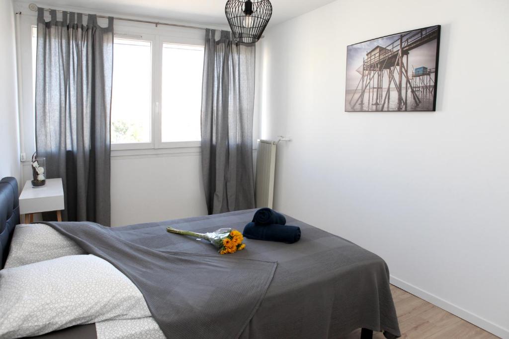 a bedroom with a bed with flowers on it at Résidence La Corvette in Toulon