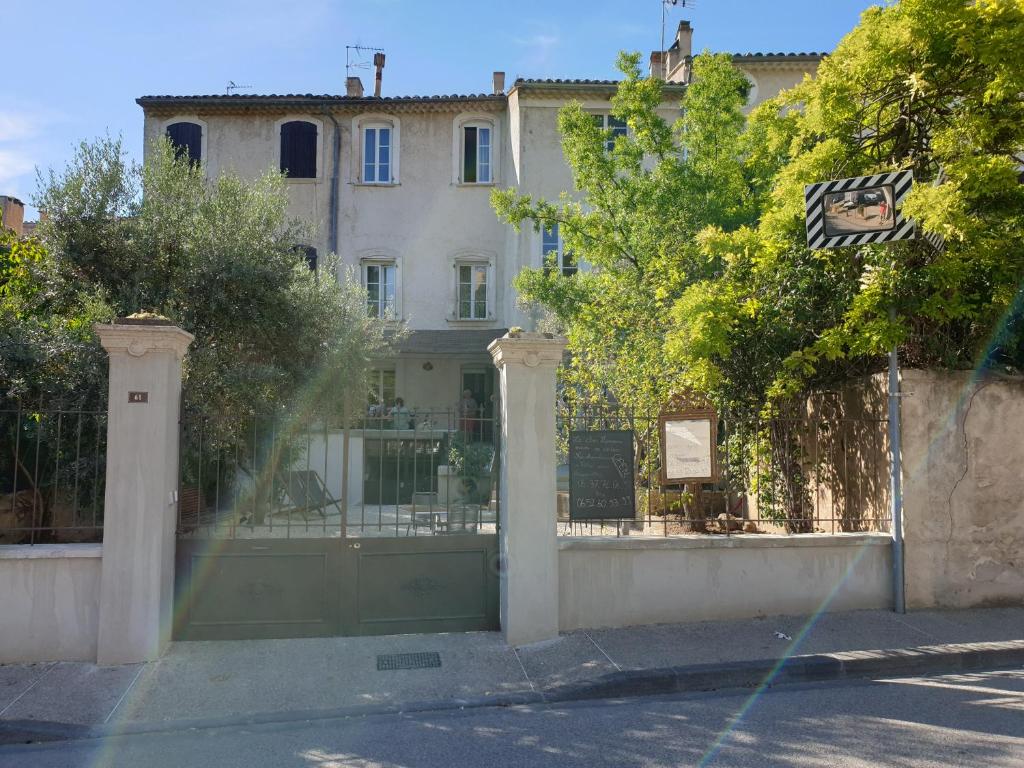 ein Haus mit einem Tor vor einem Gebäude in der Unterkunft Le Clos Marceau in Bédoin