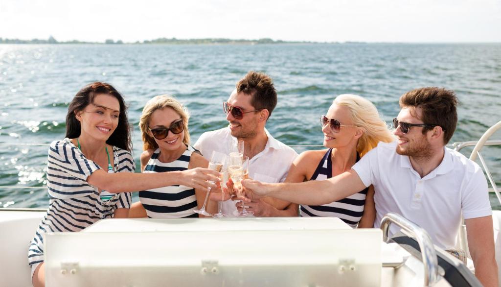 a group of people sitting at a table on a boat at AVANTI Lifestyle Hotel - Only Adults in Corralejo
