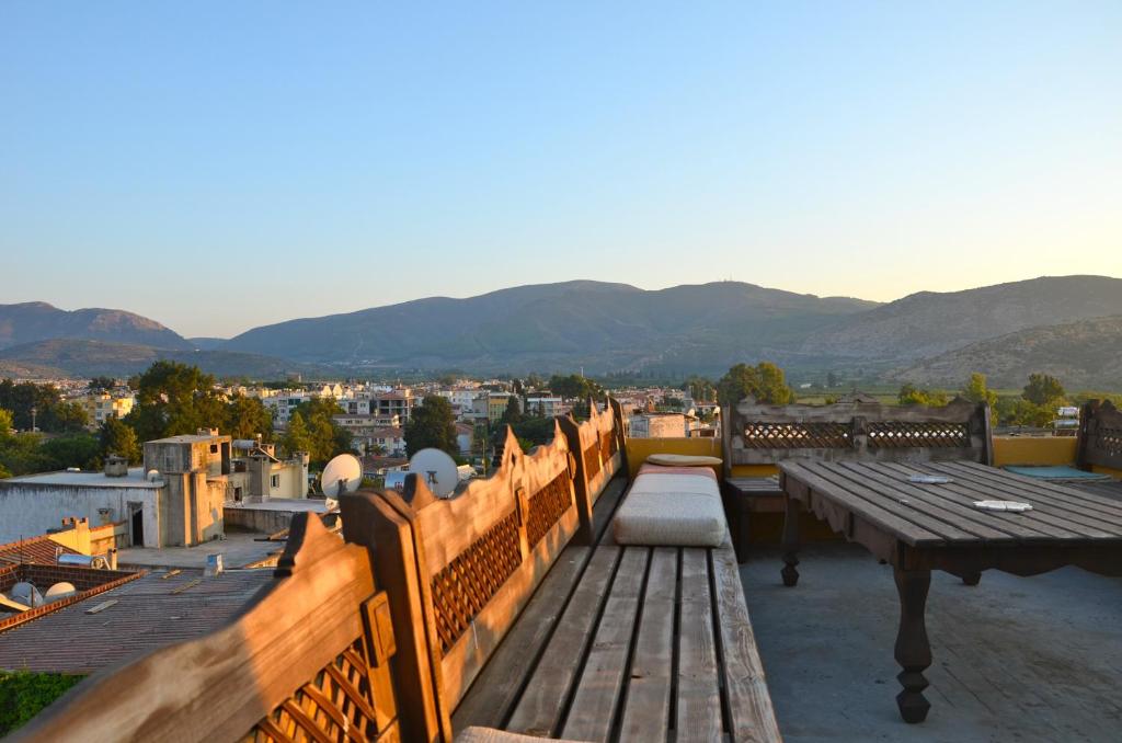 a balcony with a table and a view of a city at Homeros Pension & Guesthouse in Selcuk