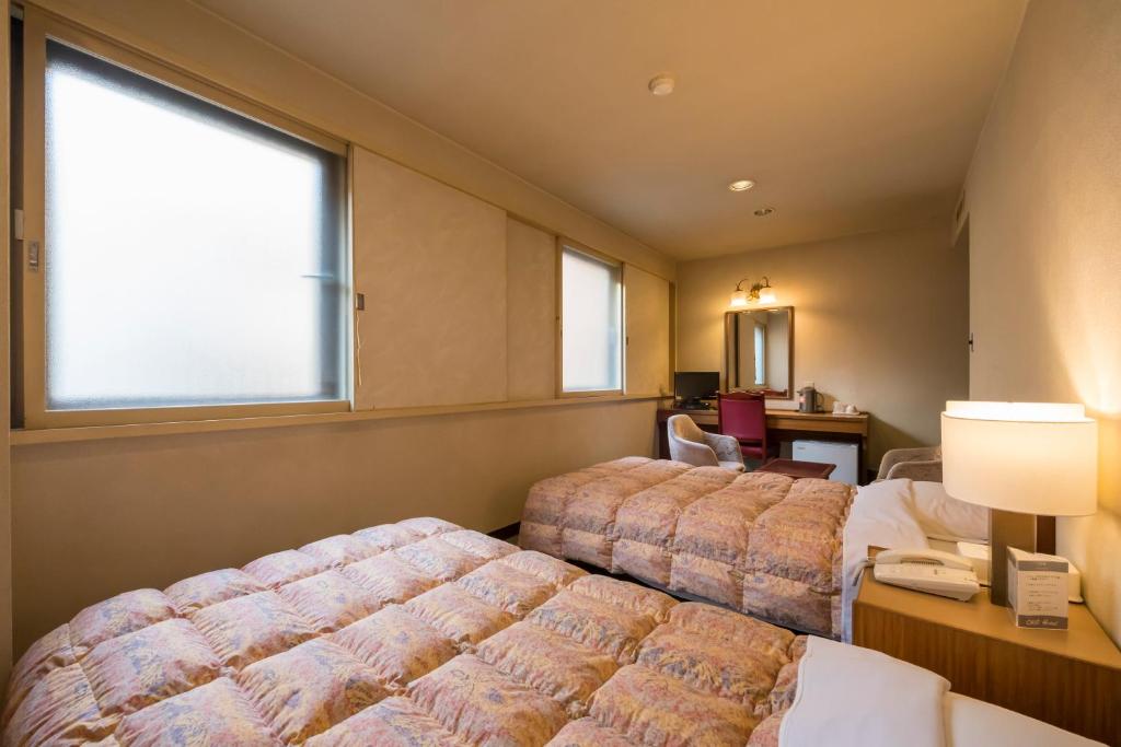 Postel nebo postele na pokoji v ubytování Oka Hotel