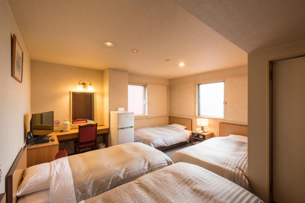 Postel nebo postele na pokoji v ubytování Oka Hotel