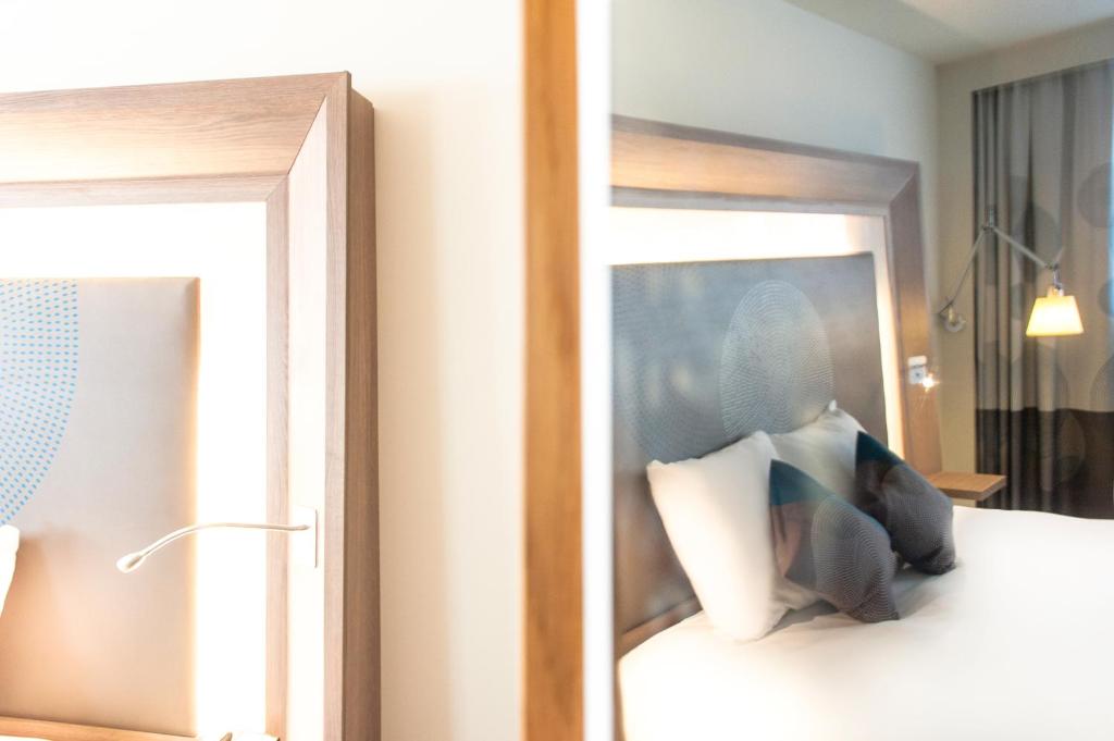 Postel nebo postele na pokoji v ubytování Novotel Mechelen Centrum