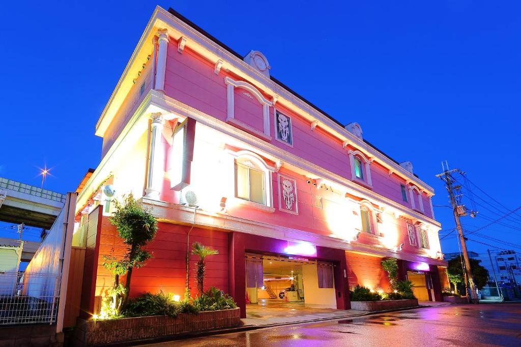 a building that is lit up at night at Hotel La Siena (Adult Only) in Higashi-osaka