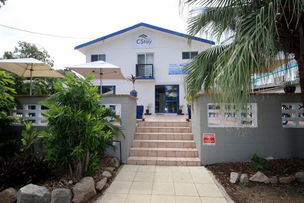 a white building with a staircase in front of it at CStay in Picnic Bay