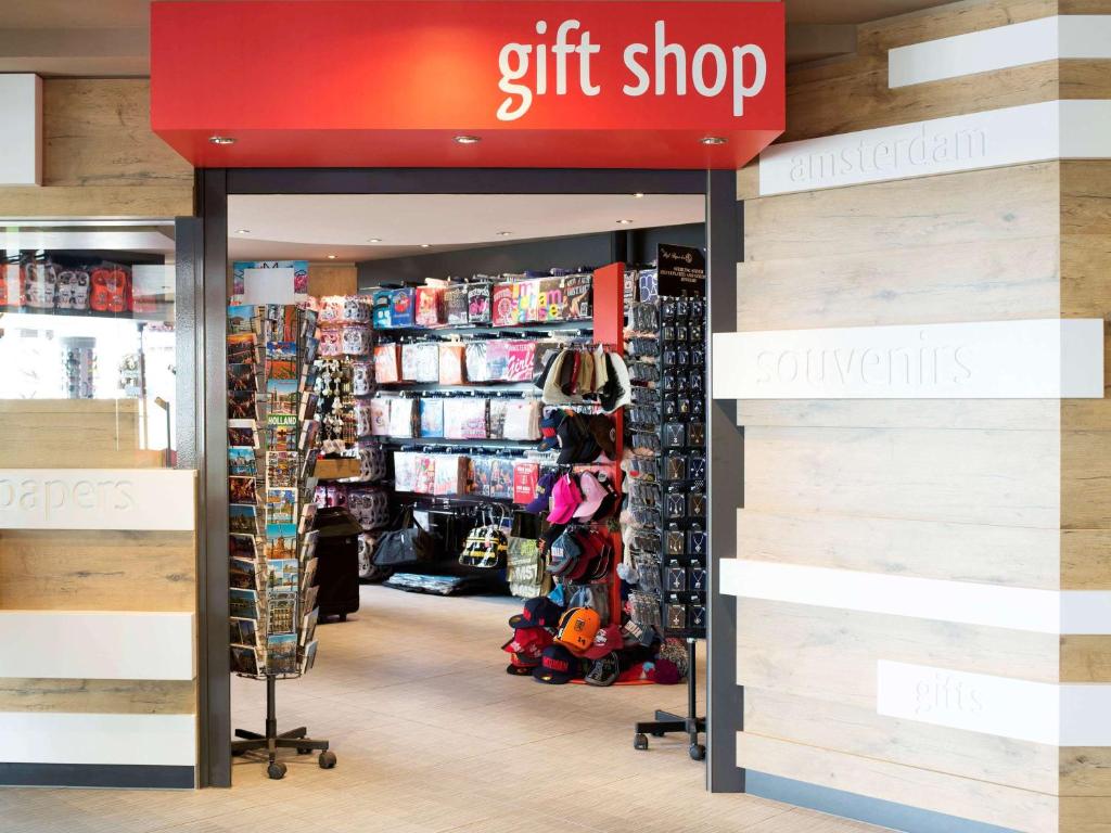 a gift shop with a red sign in a store at Ibis Schiphol Amsterdam Airport in Badhoevedorp