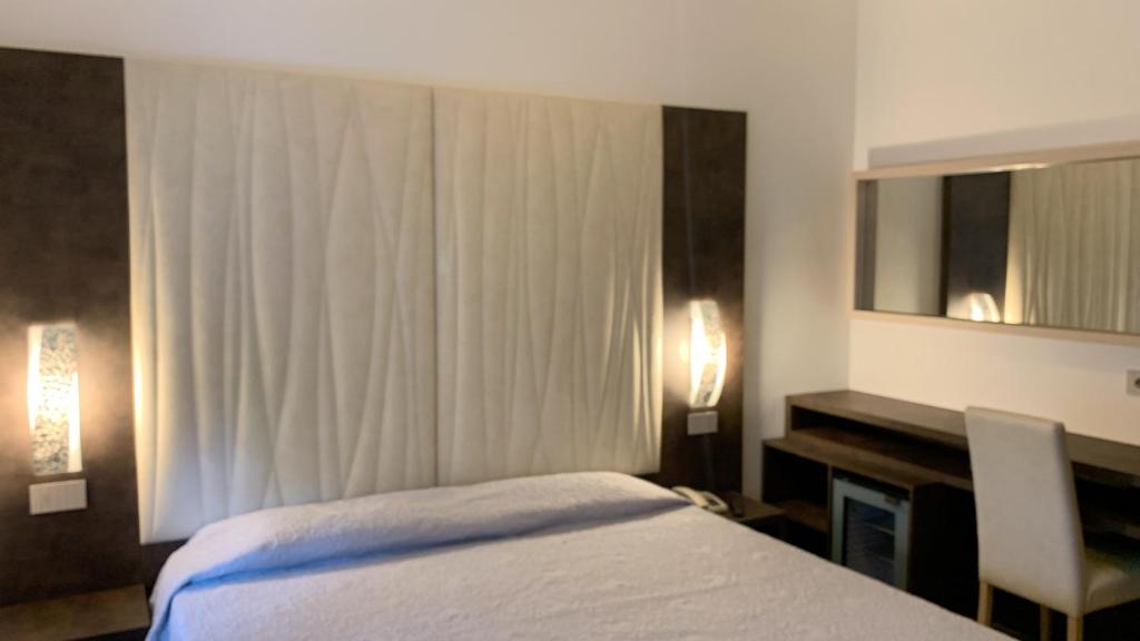 Ένα ή περισσότερα κρεβάτια σε δωμάτιο στο Albergo Gilda