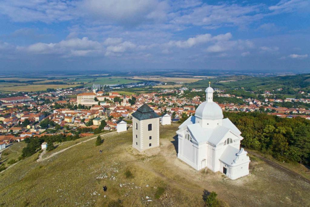 a white church on top of a hill at Apartmánek Patricie room with kitchenette suitable for 2 adults and 2 children in Mikulov