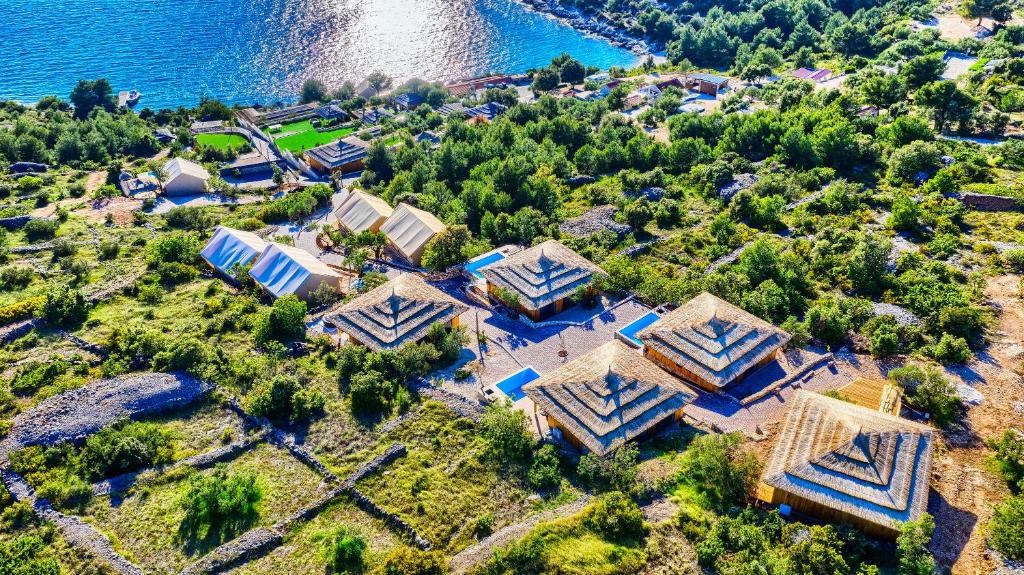 an aerial view of a house next to the water at Golden Haven Luxe Glamp Resort in Murter