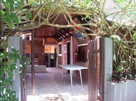 a patio with a bench in front of a building at Ronaldo's Pousada in Ilha do Mel