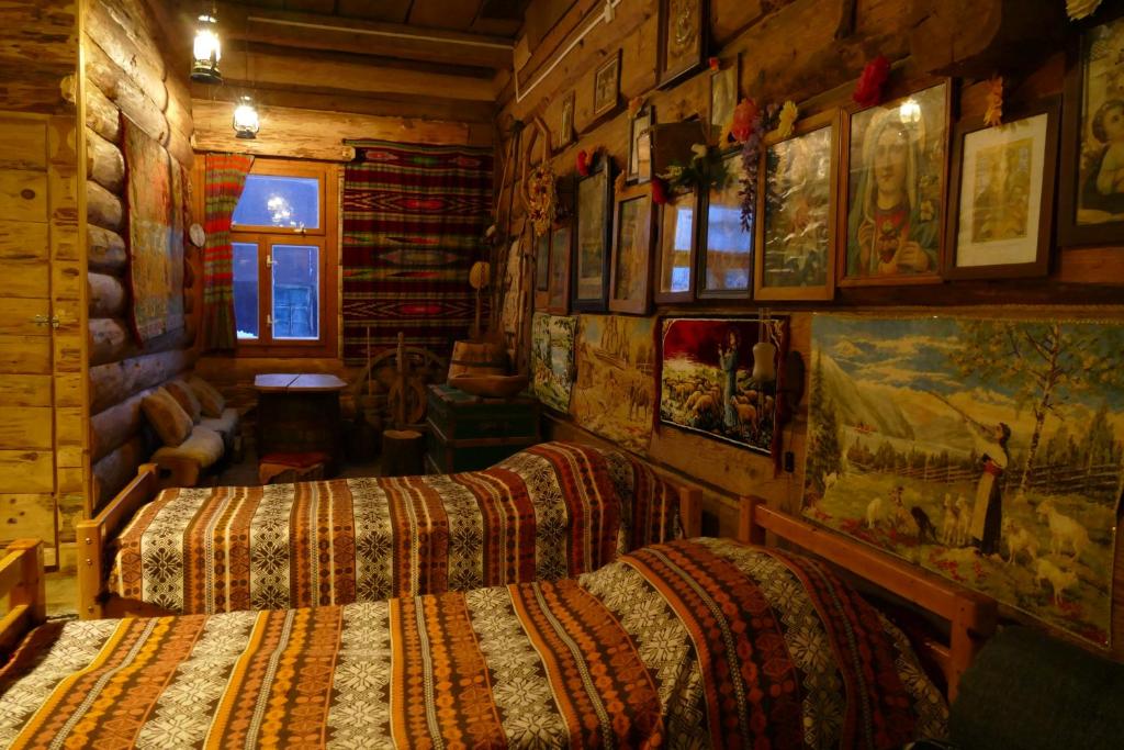 a bedroom with two beds in a log cabin at Chata Pod Kamieniem in Jaśliska